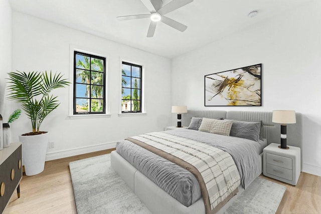 bedroom with ceiling fan and light hardwood / wood-style floors