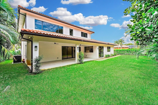 back of property featuring a lawn, central AC unit, ceiling fan, and a patio area