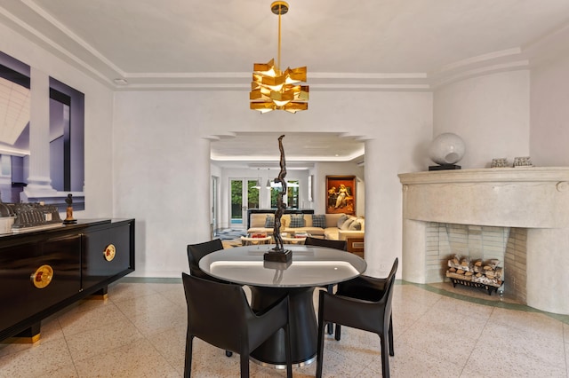 dining room with a high end fireplace and a chandelier