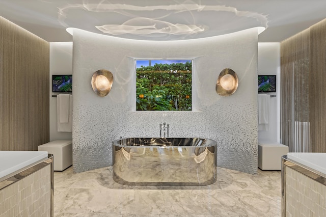 bathroom with tiled tub and tile walls