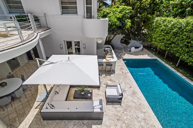 view of swimming pool with a patio area and an outdoor living space