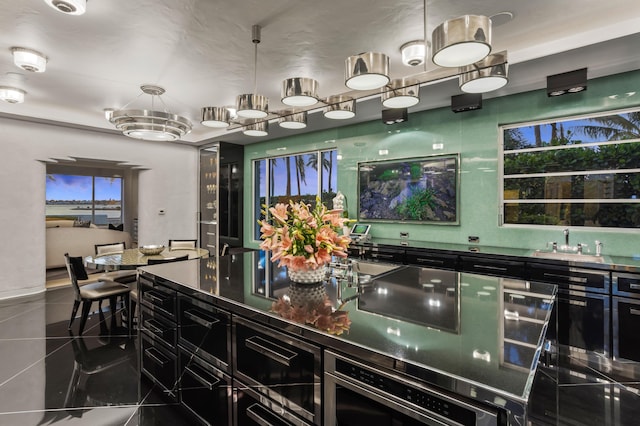 kitchen with sink and dark tile patterned flooring