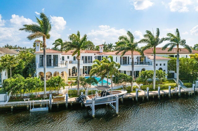 view of dock featuring a balcony and a water view