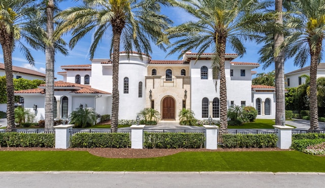 mediterranean / spanish home with a front yard