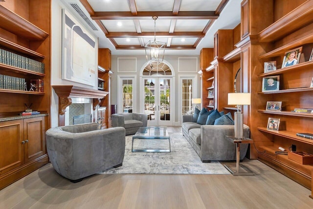 living room with french doors, coffered ceiling, light hardwood / wood-style floors, and beamed ceiling