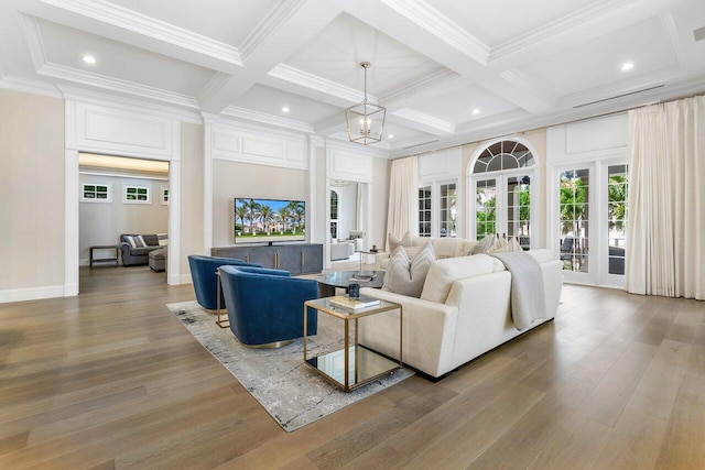 living room featuring hardwood / wood-style flooring, ornamental molding, and beamed ceiling