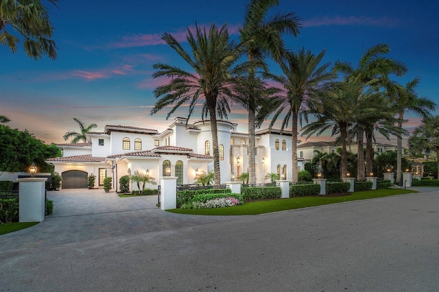 mediterranean / spanish-style house with a garage