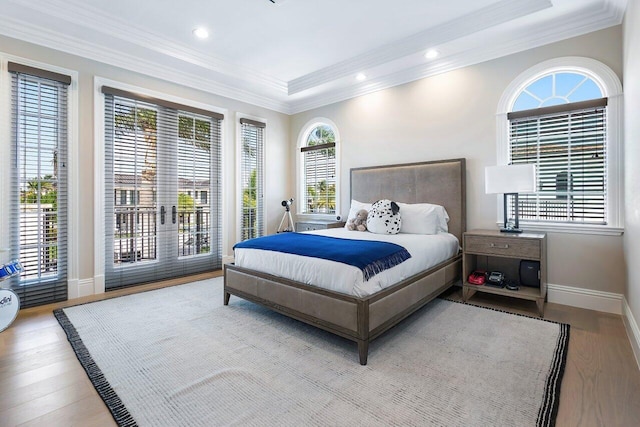 bedroom with light hardwood / wood-style flooring and ornamental molding