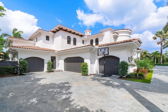 mediterranean / spanish-style home with a garage