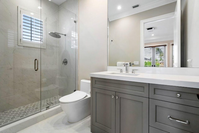 bathroom featuring a shower with door, vanity, ornamental molding, and toilet