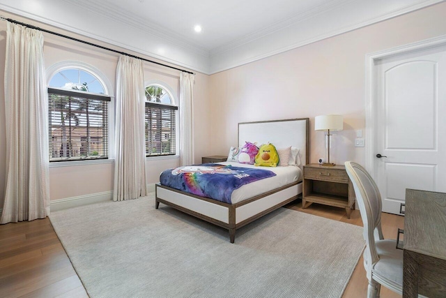 bedroom with crown molding and wood-type flooring