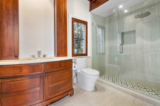 bathroom with toilet, vanity, tile patterned floors, and walk in shower