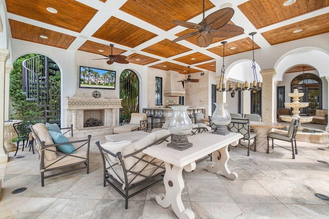 view of patio / terrace featuring ceiling fan and an outdoor fireplace