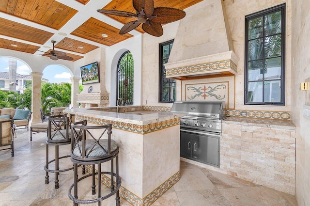 view of patio featuring a bar, area for grilling, and ceiling fan