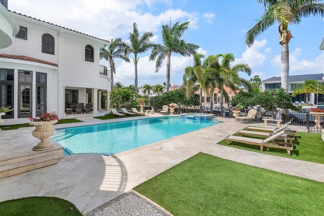 view of swimming pool with an in ground hot tub and a patio area