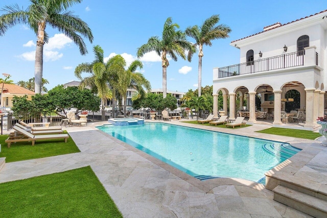 view of swimming pool with a patio and an in ground hot tub