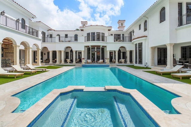 view of swimming pool featuring an in ground hot tub and a patio