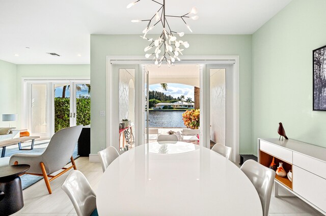 1583 Estuary Trl, Delray Beach, FL 33483 - dining room with a chandelier, a water view, visible vents, and french doors