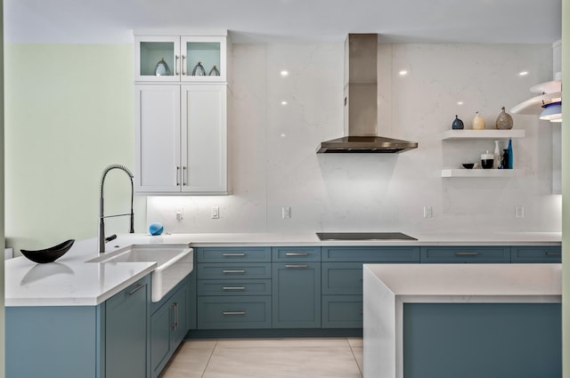 1583 Estuary Trl, Delray Beach, FL 33483 - kitchen with open shelves, a sink, black electric cooktop, light countertops, and wall chimney exhaust hood