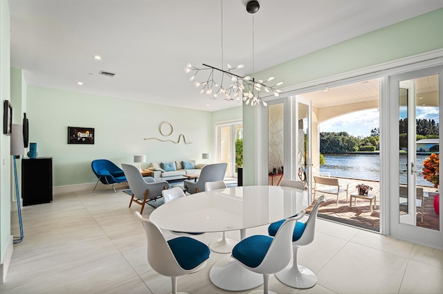 1583 Estuary Trl, Delray Beach, FL 33483 - dining space featuring an inviting chandelier, a water view, baseboards, and visible vents
