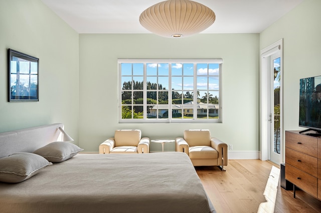 bedroom featuring access to outside and light hardwood / wood-style floors