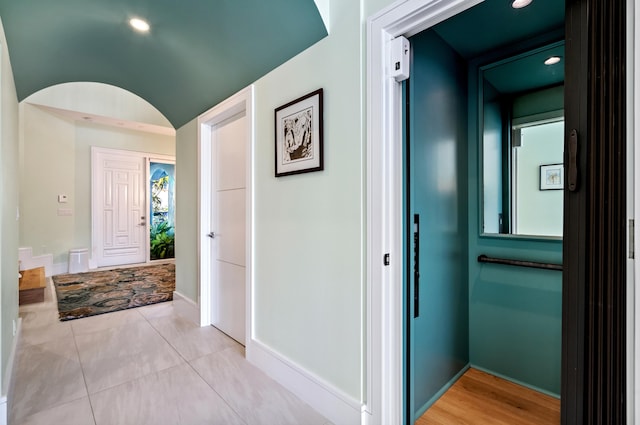 corridor featuring light tile patterned flooring