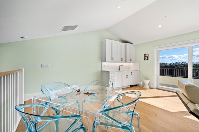 1583 Estuary Trl, Delray Beach, FL 33483 - dining room with light wood-style floors, lofted ceiling, visible vents, and baseboards