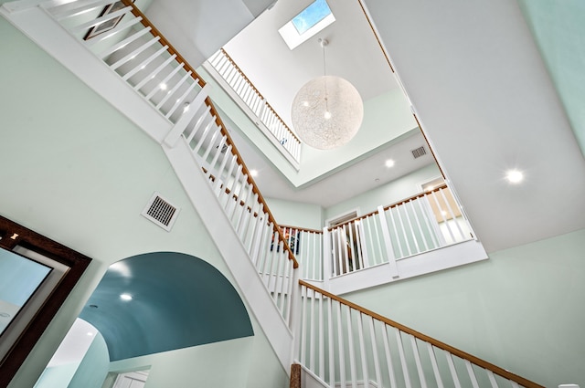 1583 Estuary Trl, Delray Beach, FL 33483 - stairway featuring visible vents, a skylight, a towering ceiling, and recessed lighting