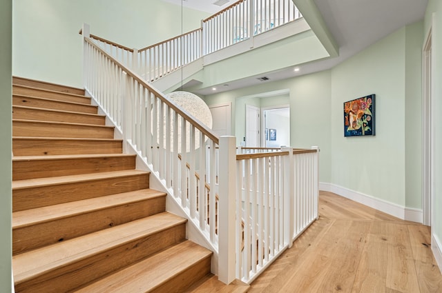 1583 Estuary Trl, Delray Beach, FL 33483 - stairway featuring recessed lighting, a towering ceiling, wood finished floors, visible vents, and baseboards