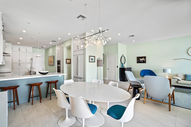 tiled dining space with an inviting chandelier