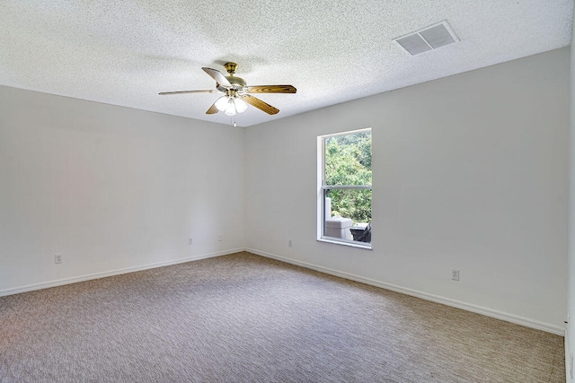 unfurnished room featuring carpet and a textured ceiling