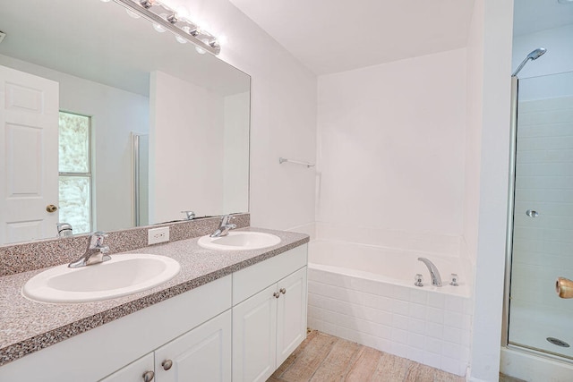 bathroom with vanity, hardwood / wood-style floors, and separate shower and tub