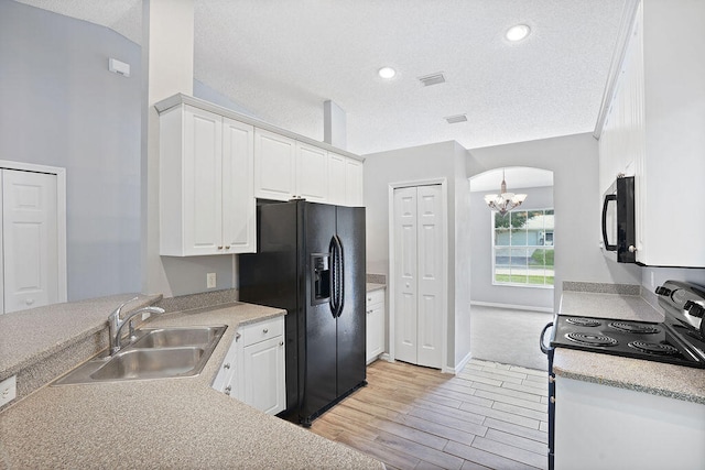 kitchen with white cabinetry, light hardwood / wood-style flooring, black appliances, and sink