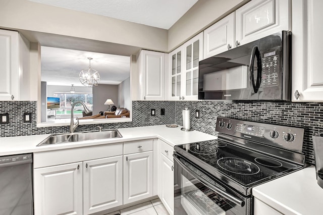 kitchen with black appliances, decorative backsplash, sink, a notable chandelier, and white cabinetry