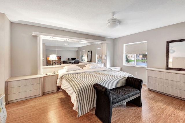 bedroom featuring light wood-type flooring and ceiling fan