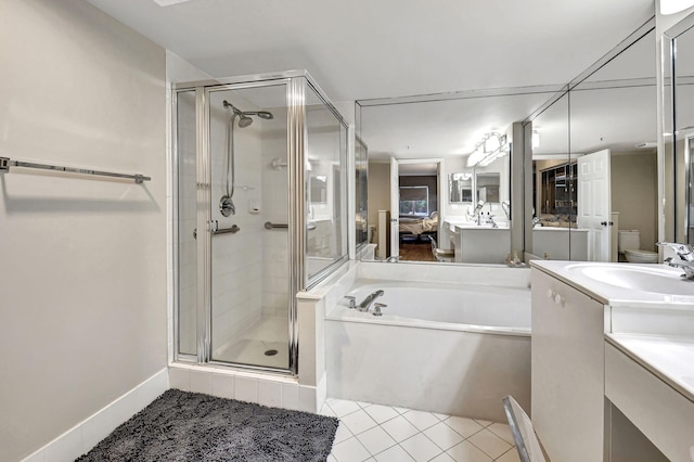 full bathroom with tile patterned floors, toilet, vanity, and independent shower and bath