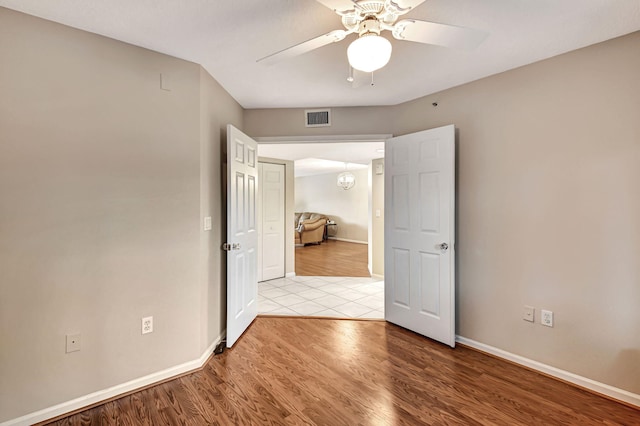 spare room featuring ceiling fan and light wood-type flooring