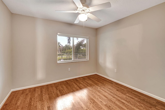 empty room with ceiling fan and light hardwood / wood-style flooring