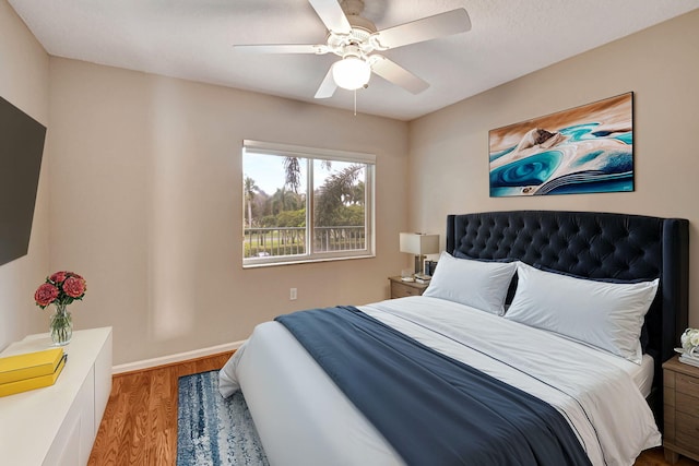 bedroom with light wood-type flooring and ceiling fan