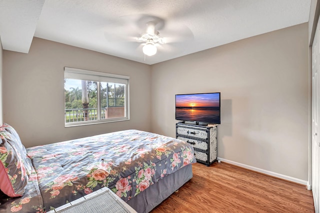 bedroom featuring a closet, hardwood / wood-style floors, and ceiling fan