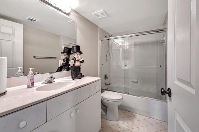 full bathroom with tile patterned floors, shower / bath combination with glass door, vanity, and toilet