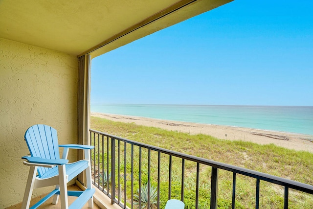 balcony with a view of the beach and a water view