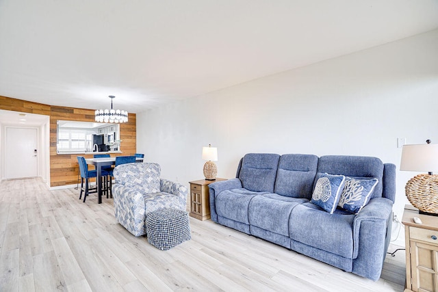 living room with light hardwood / wood-style flooring and a chandelier