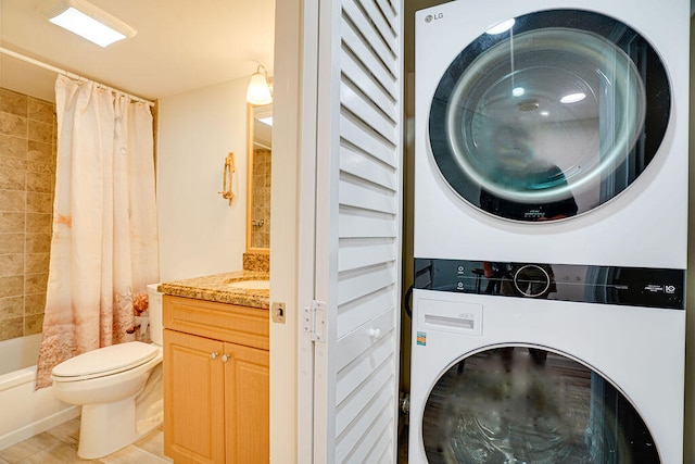 washroom featuring stacked washer / dryer