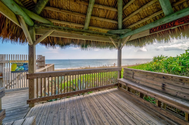 wooden deck featuring a gazebo and a water view