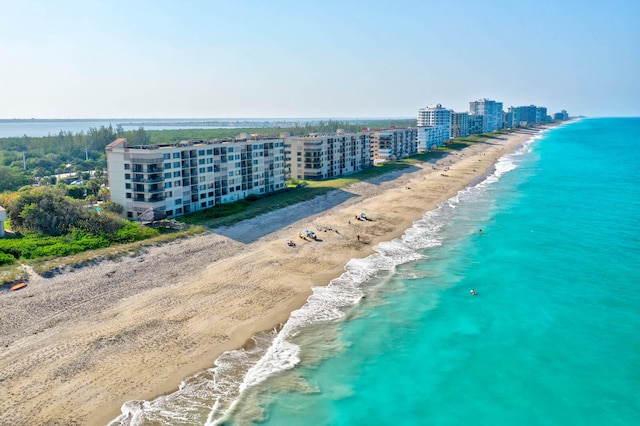 aerial view with a water view and a beach view