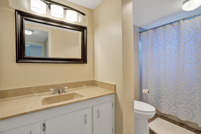 bathroom featuring a shower with curtain, hardwood / wood-style flooring, vanity, and toilet