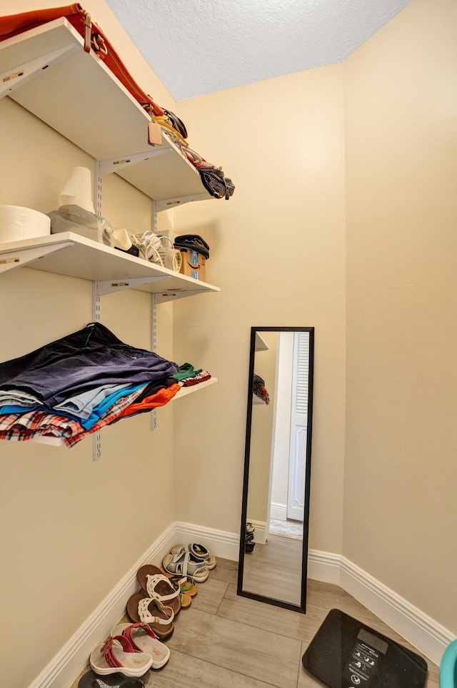 spacious closet featuring light hardwood / wood-style floors