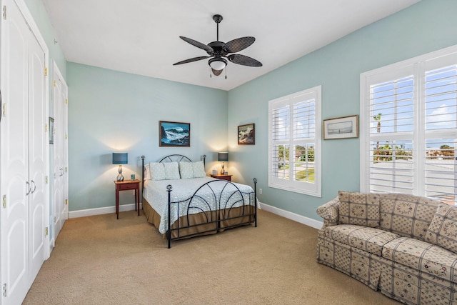 carpeted bedroom with a closet and ceiling fan