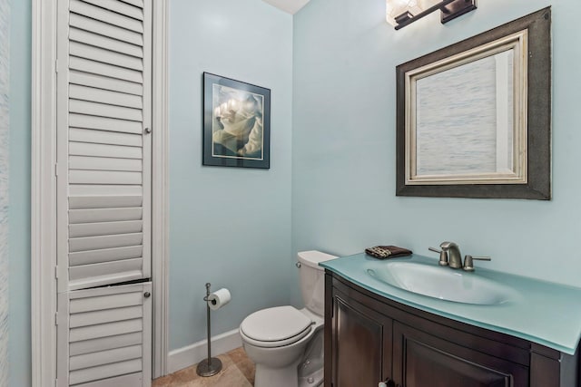 bathroom with vanity, toilet, and tile patterned floors